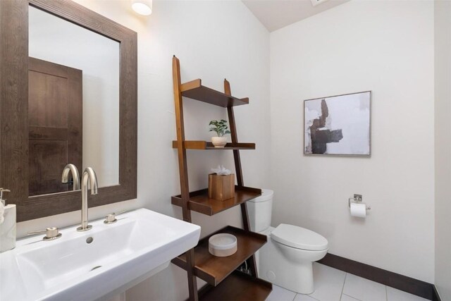 11 Glazer Trl, Silverthorne, CO 80498 - half bathroom with baseboards, toilet, tile patterned flooring, and a sink