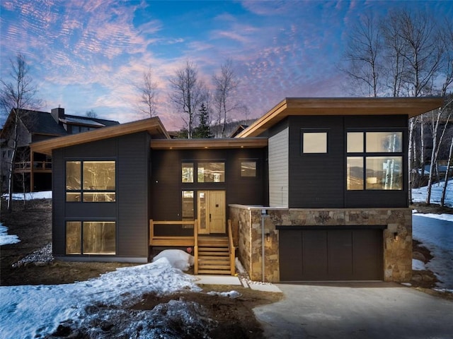 11 Glazer Trl, Silverthorne, CO 80498 - contemporary home with stone siding, an attached garage, and aphalt driveway