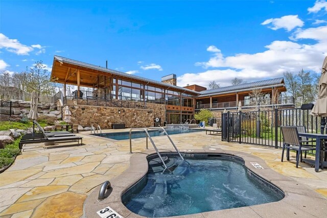 11 Glazer Trl, Silverthorne, CO 80498 - community pool featuring fence, a patio area, and a hot tub