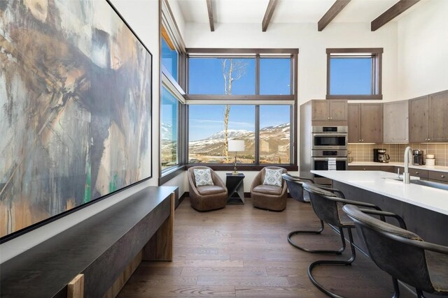 11 Glazer Trl, Silverthorne, CO 80498 - interior space with beam ceiling, a mountain view, a towering ceiling, and hardwood / wood-style flooring
