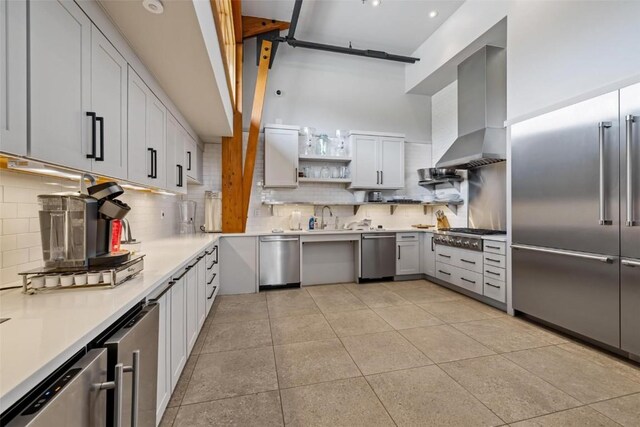 11 Glazer Trl, Silverthorne, CO 80498 - kitchen with backsplash, wall chimney exhaust hood, appliances with stainless steel finishes, and light countertops