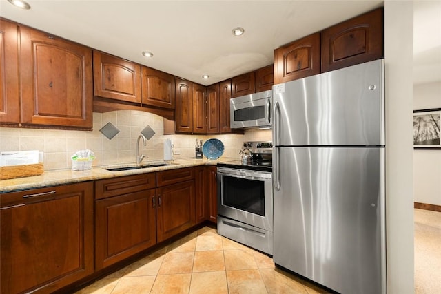 1945 Cornice Rd Unit 304 2334, Steamboat Springs, CO 80487 - kitchen with light stone countertops, recessed lighting, a sink, decorative backsplash, and appliances with stainless steel finishes