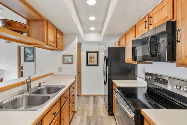 kitchen featuring a sink, electric range, light wood-style floors, black microwave, and light countertops