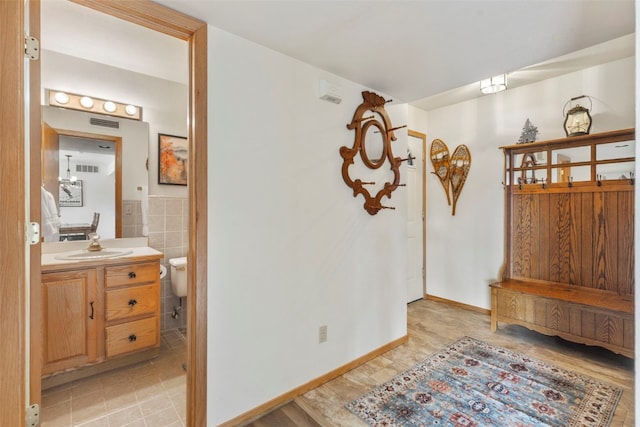 interior space featuring visible vents, light tile patterned floors, and a sink