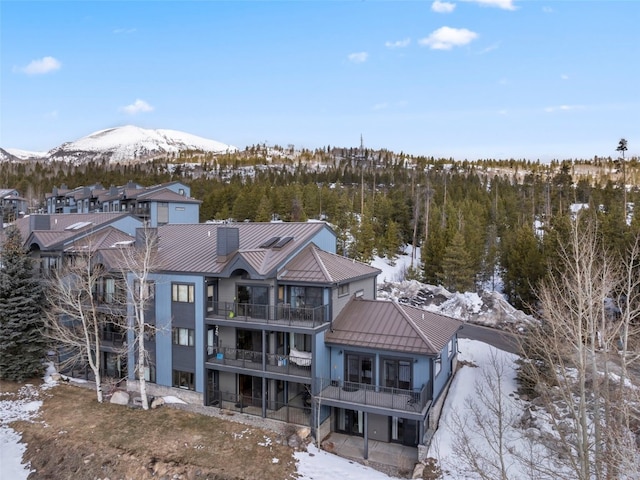 snowy aerial view with a mountain view