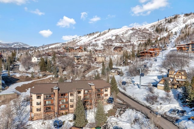 snowy aerial view with a mountain view