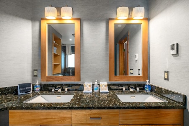 full bath with a sink and double vanity