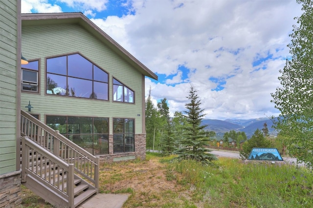 2300 Lodge Pole Cir Unit 105, Wildernest, CO 80498 - view of property exterior featuring a mountain view and stairway