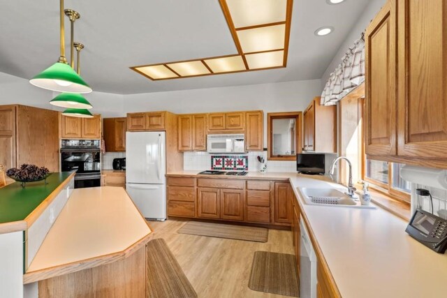 34995 Country Green Rd, Steamboat Springs, CO 80487 - kitchen featuring tasteful backsplash, a sink, brown cabinets, white appliances, and light wood finished floors