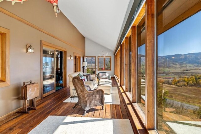 34995 Country Green Rd, Steamboat Springs, CO 80487 - sunroom / solarium featuring wood-type flooring, lofted ceiling, and a mountain view