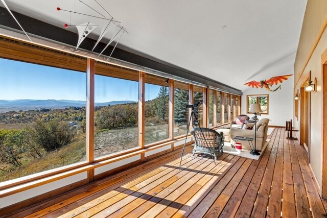 34995 Country Green Rd, Steamboat Springs, CO 80487 - sunroom with hardwood / wood-style flooring, vaulted ceiling, and a mountain view