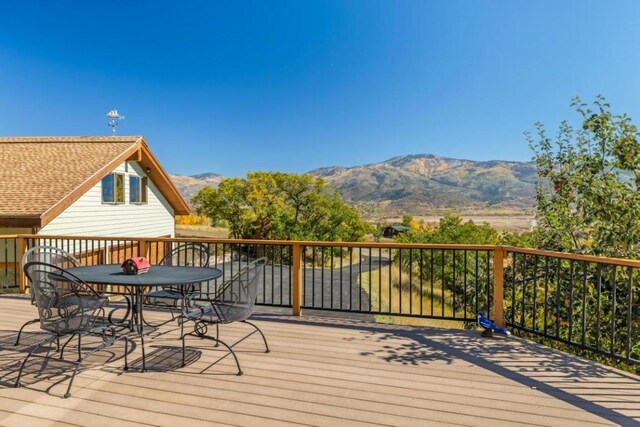 34995 Country Green Rd, Steamboat Springs, CO 80487 - wooden deck featuring outdoor dining space and a mountain view