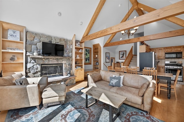 773 Range Rd, Breckenridge, CO 80424 - living room with stairway, beamed ceiling, light wood-type flooring, a chandelier, and a fireplace