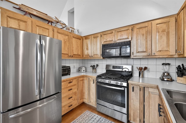 773 Range Rd, Breckenridge, CO 80424 - kitchen featuring appliances with stainless steel finishes, light countertops, backsplash, dark wood-style flooring, and vaulted ceiling