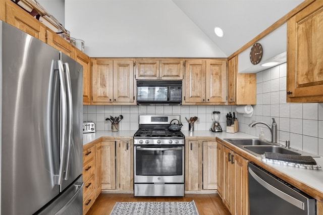 773 Range Rd, Breckenridge, CO 80424 - kitchen with appliances with stainless steel finishes, lofted ceiling, light countertops, and decorative backsplash