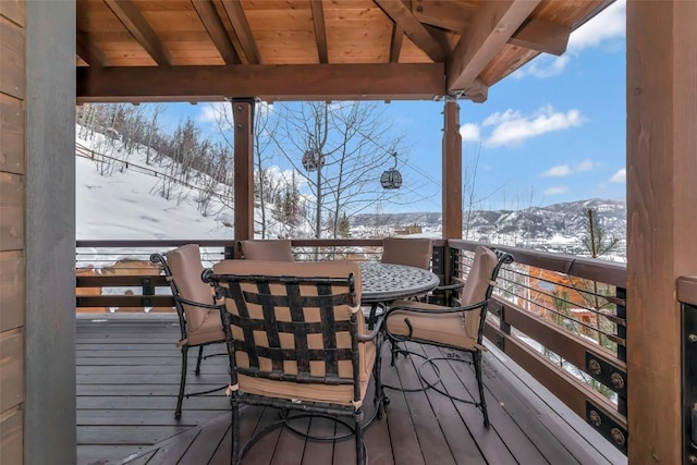 2542 Ski Trail Ln, Steamboat Springs, CO 80487 - snow covered deck featuring a mountain view and outdoor dining area