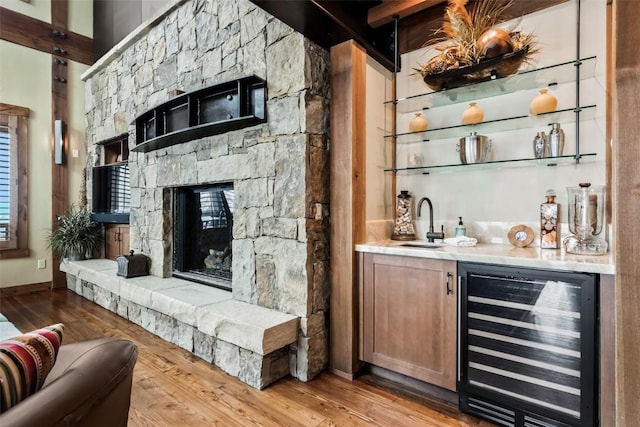 2542 Ski Trail Ln, Steamboat Springs, CO 80487 - bar with wood finished floors, a sink, indoor wet bar, baseboards, and wine cooler