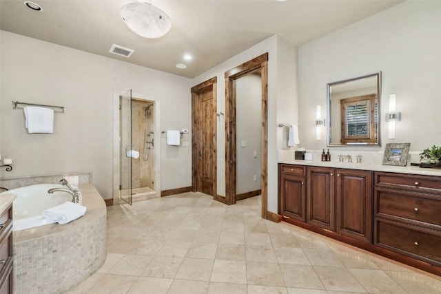 2542 Ski Trail Ln, Steamboat Springs, CO 80487 - full bath with tile patterned flooring, a bath, vanity, visible vents, and a stall shower