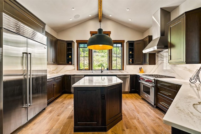 455 Highfield Trl, Breckenridge, CO 80424 - kitchen featuring high end appliances, wall chimney exhaust hood, light stone counters, dark brown cabinetry, and recessed lighting