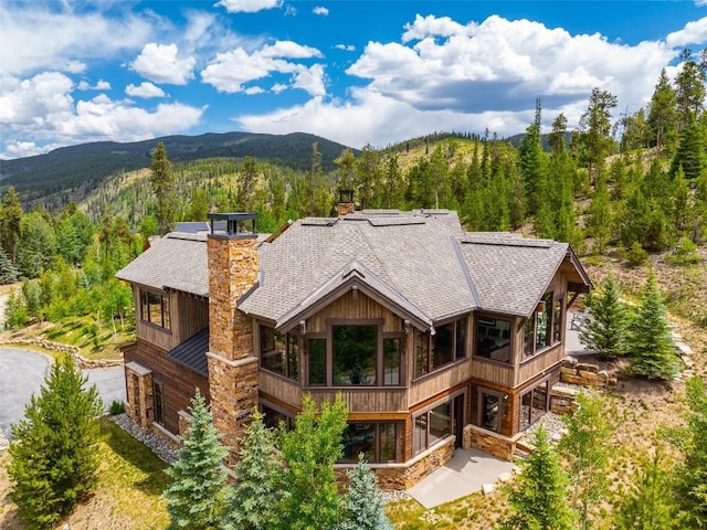 455 Highfield Trl, Breckenridge, CO 80424 - back of property with a mountain view, stone siding, and a view of trees