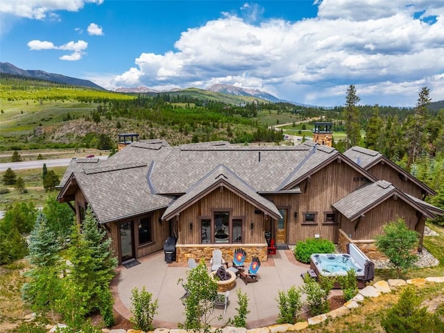 455 Highfield Trl, Breckenridge, CO 80424 - rear view of house with roof with shingles, a patio, and a mountain view