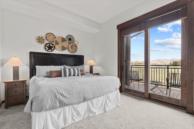 carpeted bedroom with access to outside and a mountain view