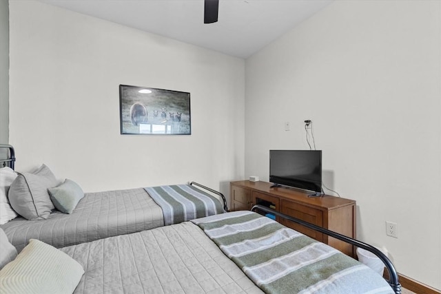 bedroom with baseboards and a ceiling fan