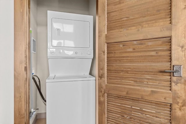washroom with laundry area and stacked washer / drying machine