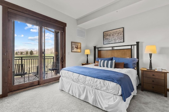 carpeted bedroom with access to outside, visible vents, and a mountain view