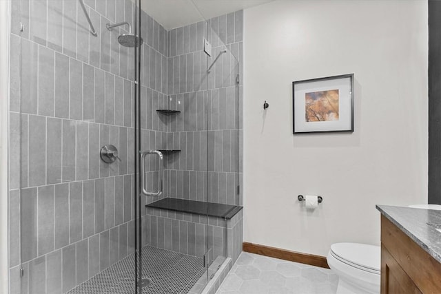 full bathroom with tile patterned flooring, vanity, toilet, baseboards, and a stall shower