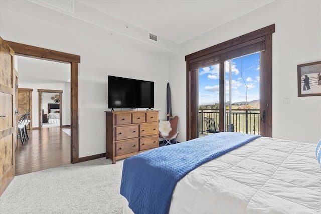 bedroom featuring baseboards, access to outside, light carpet, and visible vents