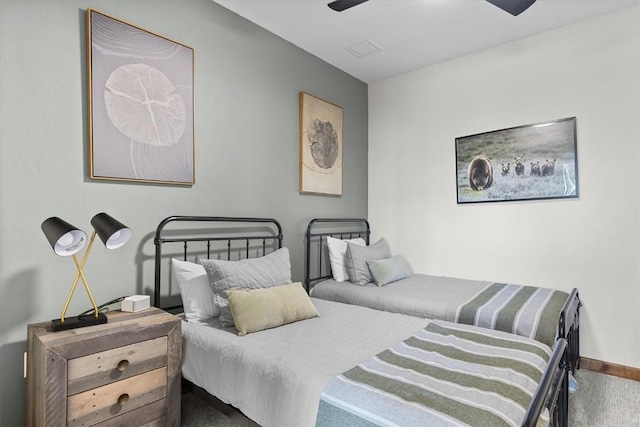 carpeted bedroom with a ceiling fan and visible vents