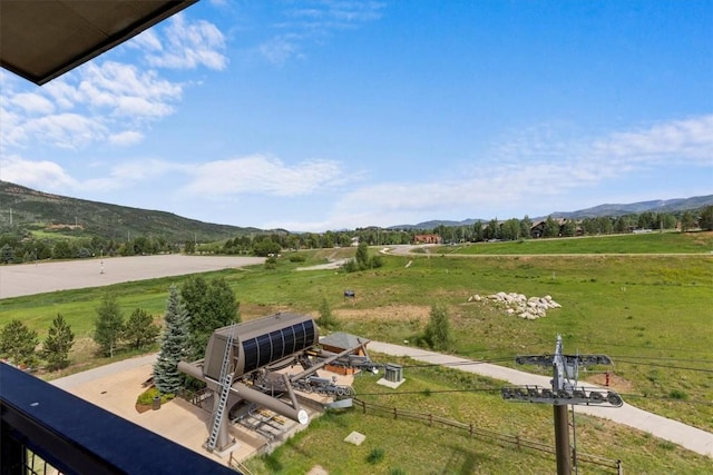 exterior space with fence, a mountain view, and a rural view