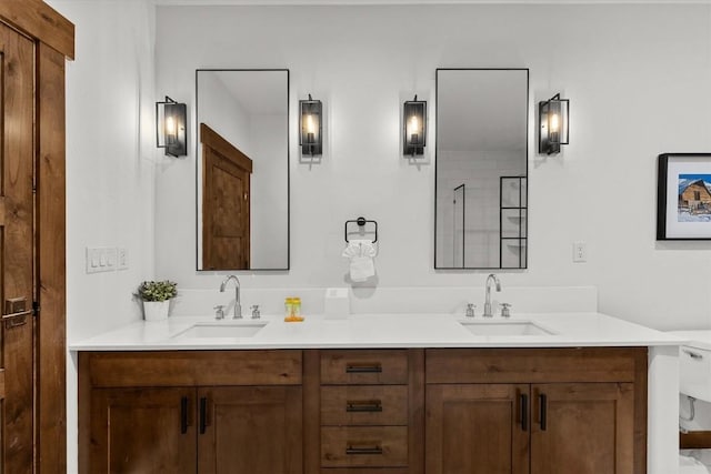 bathroom featuring double vanity, a sink, and toilet