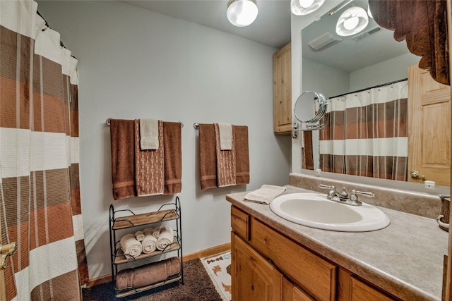 bathroom featuring baseboards, visible vents, vanity, and a shower with curtain