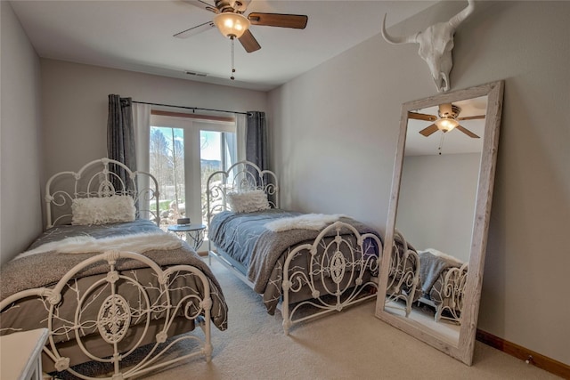 carpeted bedroom with visible vents and ceiling fan