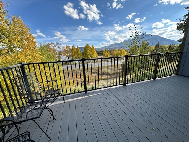 wooden deck with a mountain view