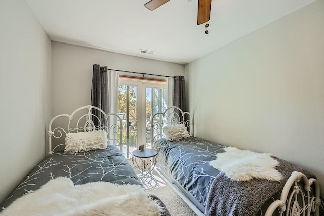 bedroom with visible vents, carpet floors, and ceiling fan