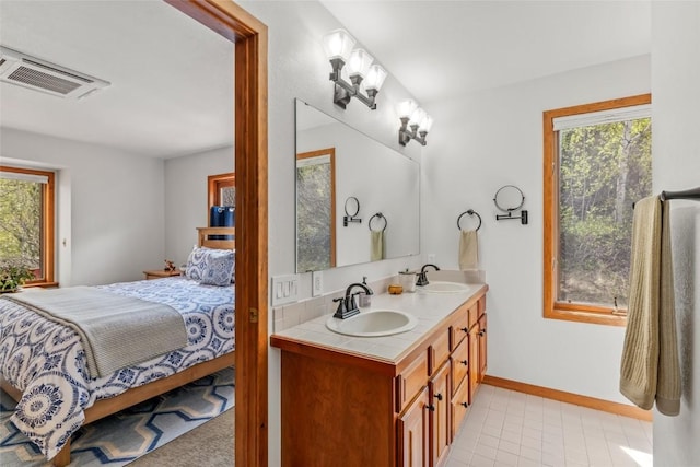 663 Amethyst Dr, Steamboat Springs, CO 80487 - ensuite bathroom featuring plenty of natural light, double vanity, and baseboards