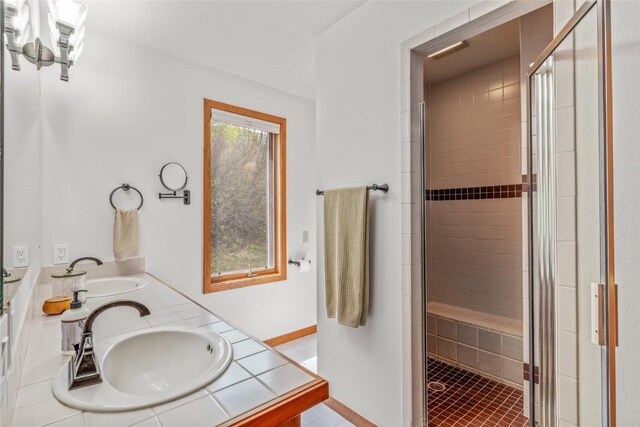 663 Amethyst Dr, Steamboat Springs, CO 80487 - bathroom with a shower stall, double vanity, baseboards, and tile patterned floors