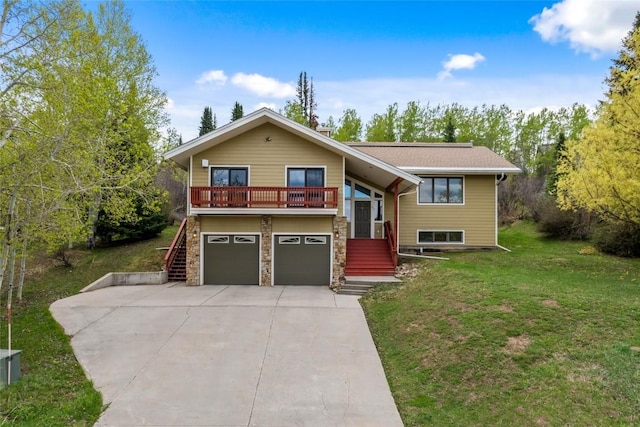 663 Amethyst Dr, Steamboat Springs, CO 80487 - raised ranch with stairway, a front lawn, an attached garage, driveway, and stone siding