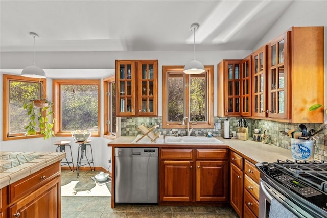 663 Amethyst Dr, Steamboat Springs, CO 80487 - kitchen with appliances with stainless steel finishes, a sink, backsplash, and hanging light fixtures