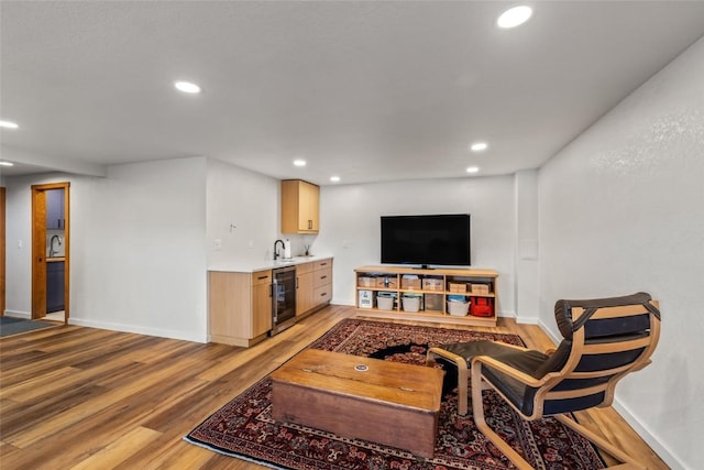 663 Amethyst Dr, Steamboat Springs, CO 80487 - living room with beverage cooler, bar with sink, light wood-type flooring, recessed lighting, and baseboards