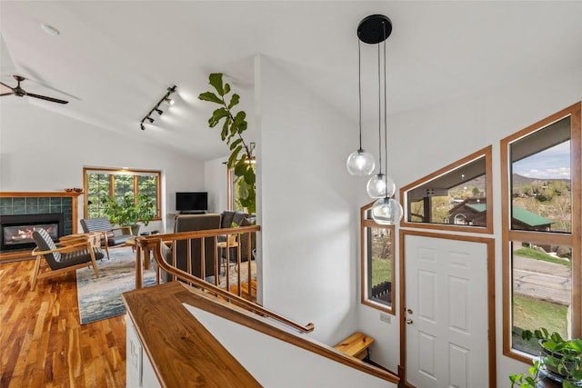 663 Amethyst Dr, Steamboat Springs, CO 80487 - entryway with vaulted ceiling, wood finished floors, track lighting, a fireplace, and a ceiling fan