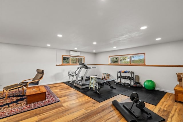 663 Amethyst Dr, Steamboat Springs, CO 80487 - exercise area with a wall unit AC, recessed lighting, wood finished floors, and healthy amount of natural light