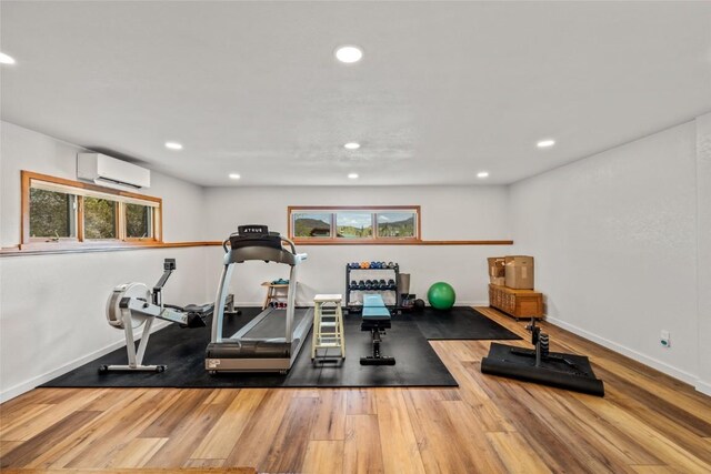 663 Amethyst Dr, Steamboat Springs, CO 80487 - workout area featuring an AC wall unit, wood finished floors, recessed lighting, healthy amount of natural light, and baseboards