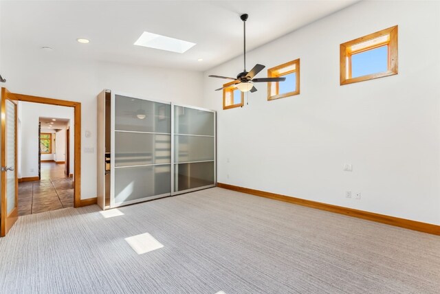 475 Vail Cir, Dillon, CO 80435 - spare room featuring a skylight, carpet, plenty of natural light, baseboards, and lofted ceiling