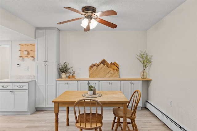 921 Fairview Blvd Unit 14, Breckenridge, CO 80424 - dining space with a baseboard radiator, light wood-type flooring, ceiling fan, and a textured ceiling