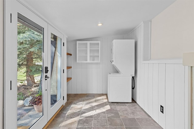 921 Fairview Blvd Unit 14, Breckenridge, CO 80424 - laundry room with stacked washer and clothes dryer, stone finish floors, and a decorative wall