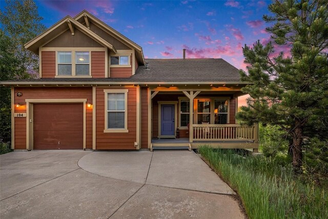 104 Saddle Horn Ct, Granby, CO 80446 - view of front of home featuring an attached garage, driveway, and covered porch